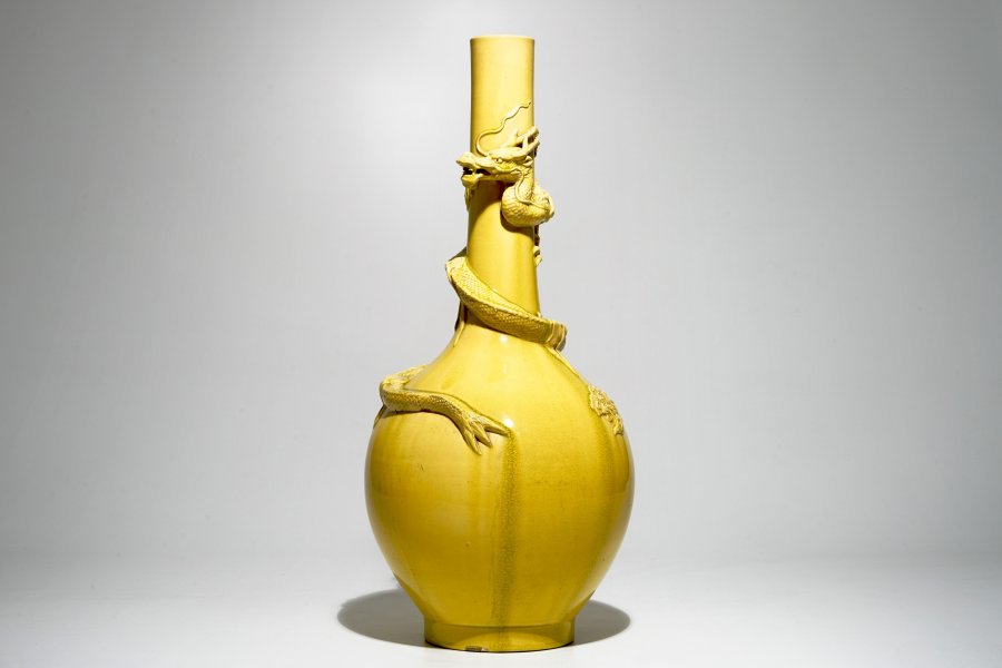 A tall Japanese Awaji monochrome yellow vase with applied dragon design, Meiji, late 19th C.